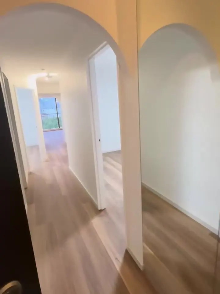 After: freshly plastered and painted hallway with arches