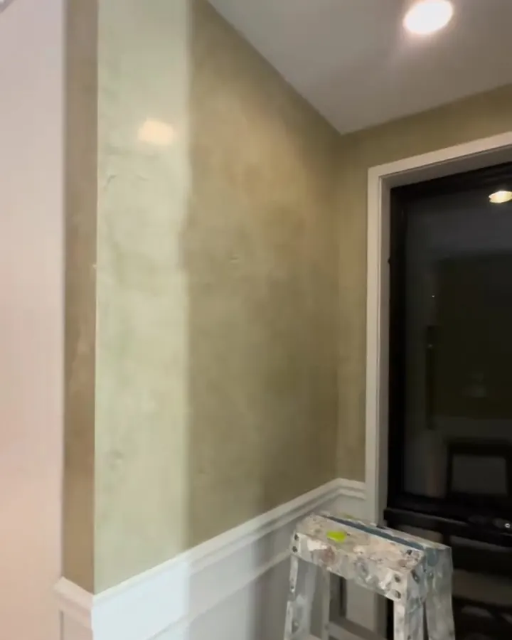 Venetian plaster feature wall above white wall panelling