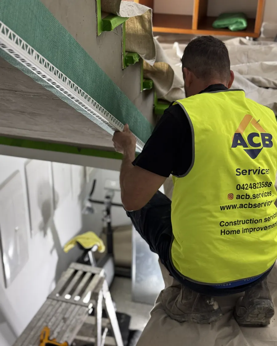 ACB plasterer fitting a cornice